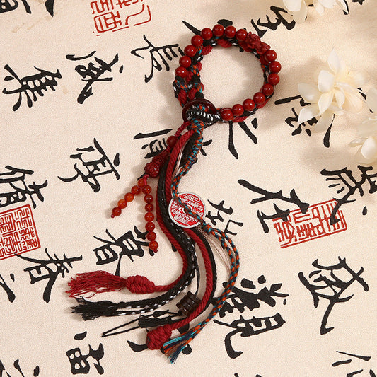 Mountain Ghost - Vermilion Agate Charm Bracelet with tassels on calligraphy background.