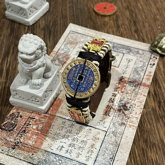 Mountain Ghost - Flowing Harmony Bracelet with blue coin centerpiece on wooden surface with decorative elements.